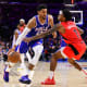 Toronto Raptors guard Armoni Brooks (1) reaches across Philadelphia 76ers forward Tobias Harris (12) in the fourth quarter at Wells Fargo Center.